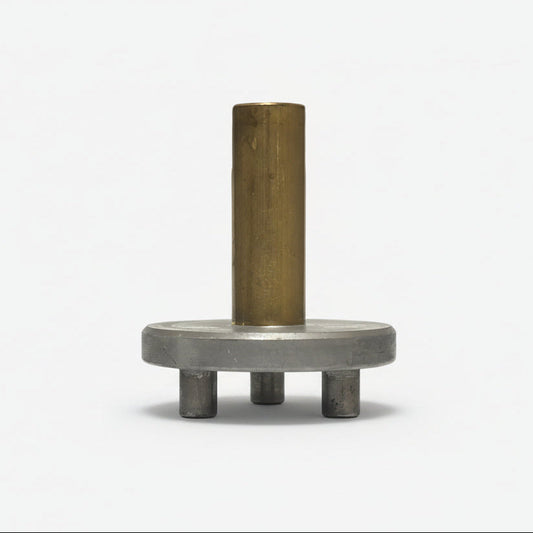 Metal component with cylindrical brass part and metal base on a white background