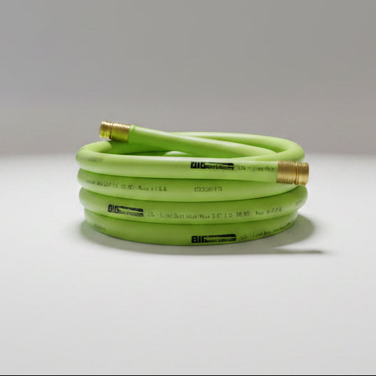 Green water hose with brass fittings on a white background